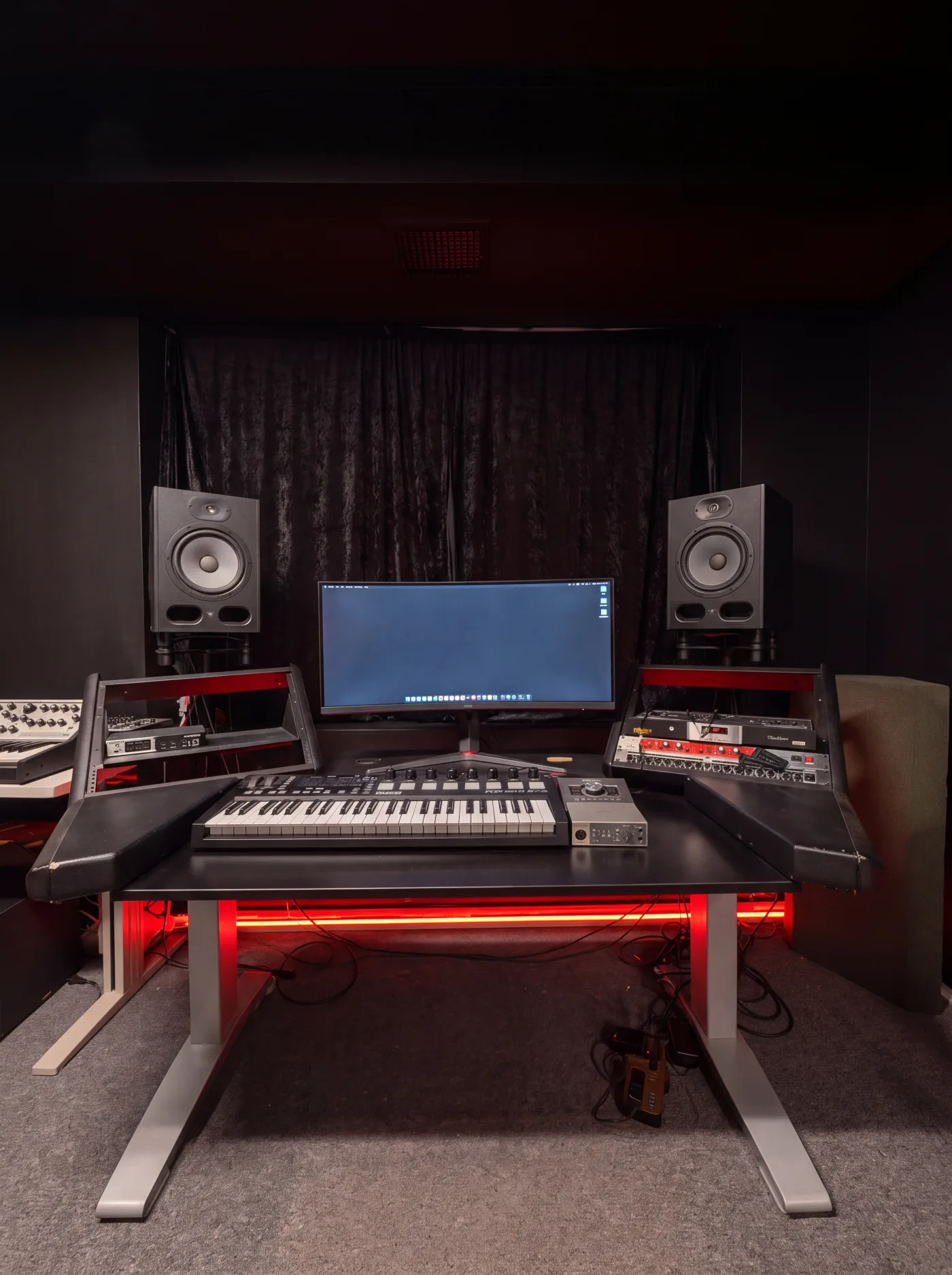 Demo Room music studio: production desk with studio monitors, keyboard controller, and outboard racks